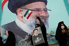 A supporter of Ebrahim Raisi displays his portrait during a celebratory rally for his presidential election victory in Tehran, Iran, June 19, 2021 Photo by Majid Asgaripour/West Asia News Agency via Reuters