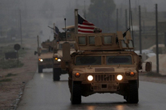 U.S. military vehicles in Syria’s northern city of Manbij on Dec. 30. (Delil Souleiman/AFP)