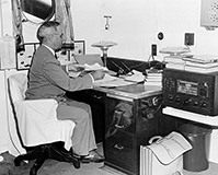 President Harry Truman reading reports of dropping the first atomic bomb