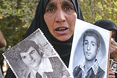 Iraqi woman holding archival photos