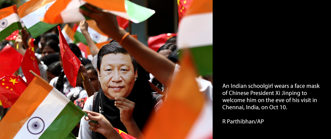 Indian schoolgirl wears a face mask of Chinese President Xi Jinping