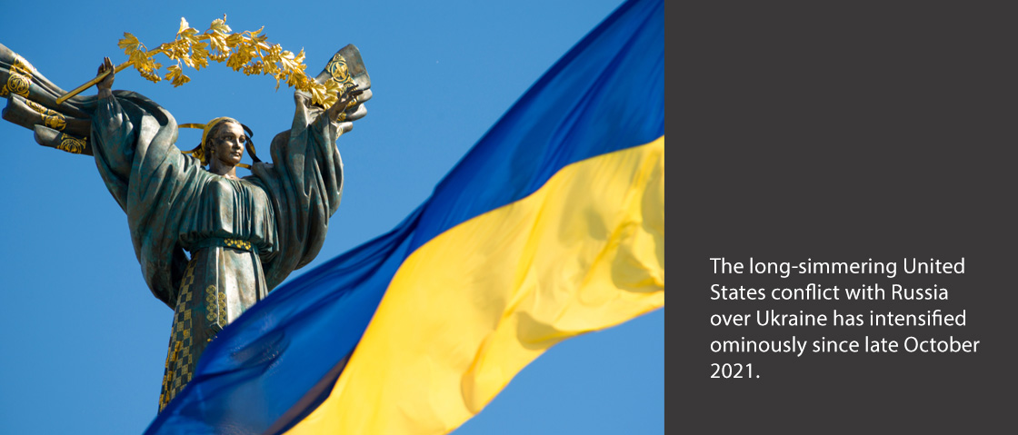 Monument of Independence - a column with a figure of a woman with a branch of a guelder-rose on her hands. In the foreground the Ukrainian flag