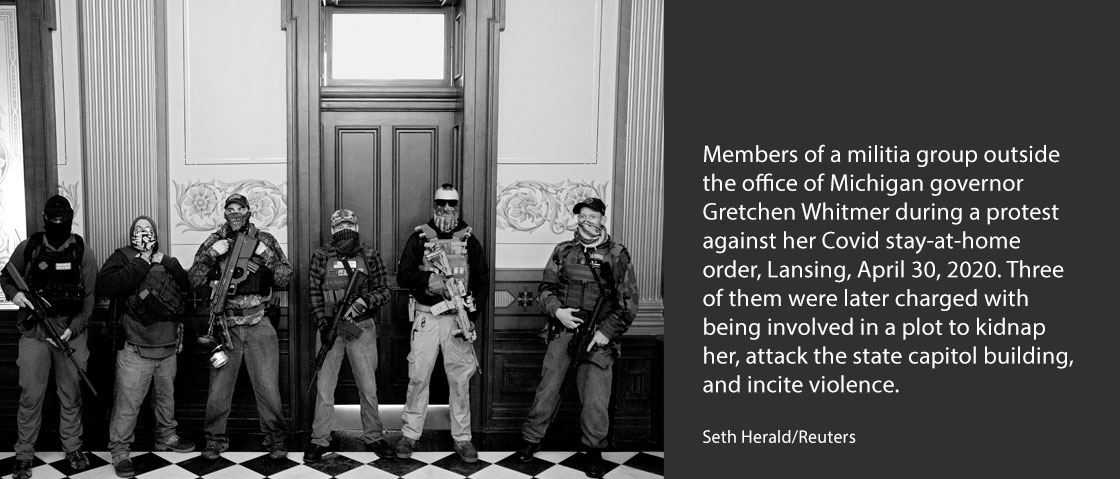 Members of a militia group outside the office of Michigan governor Gretchen Whitmer during a protest against her Covid stay-at-home order, Lansing, April 30, 2020. Three of them were later charged with being involved in a plot to kidnap her, attack the state capitol building, and incite violence.