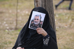 An Iranian woman covers her face with a picture of Iranian Maj. Gen. Qassem Soleimani during a demonstration in Tehran against the killing of the top commander in a U.S. strike in Baghdad. (Atta Kenare/AFP/Getty Images)