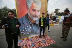 Posing for a picture with a poster of Maj Gen Qassim Suleimani in Baghdad on Saturday.Credit...Ahmad Al-Rubaye/Agence France-Presse — Getty Images