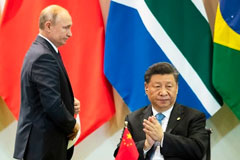 Chinese President Xi Jinping, right, and Russian President Vladimir Putin during the BRICS summit in Brasilia, Brazil, Nov. 14, 2019 (AP photo by Pavel Golovkin).