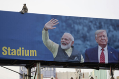  A monkey sits atop a billboard that shows India’s Prime Minister Narenda Modi welcoming President Trump ahead of his visit to Ahmedabad, India, on Monday. (Ajit Solanki / Associated Press)