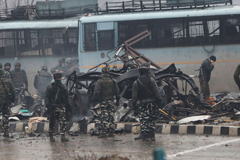 Indian security forces inspect the remains of a vehicle following an attack in Kashmir on Feb. 14. Photographer: AFP via Getty Images