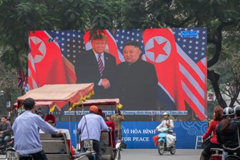 President Donald Trump and North Korean leader Kim Jong Un on a large screen, February 28, in Hanoi, Vietnam. Carl Court/Getty Images