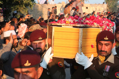 Pakistani soldiers carry a coffin of Pakistani soldier Khuram Ali who reportedly lost his life during heavy shelling from Indian troops at the Line of Control in Pakistani Kashmir, during his funeral in Dera Ghazi Khan in Pakistan, Monday, March 4, 2019. (Asim Tanveer)