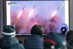 North Korea carried out another launch of projectiles on Monday, a week after a similar exercise [Ahn Young-joon/AP Photo] Koreans watching news coverage of the launch on tv.