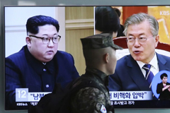 A TV screen at Seoul Railway Station shows file footage of North Korean leader Kim Jong Un, left, and South Korean President Moon Jae-in on Wednesday. (Ahn Young-Joon/AP)