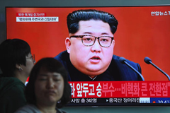 People walk past a television news screen showing a file footage of North Korean leader Kim Jong Un, at a railway station in Seoul on April 21, 2018. Jung Yeon-je/AFP/Getty Images 