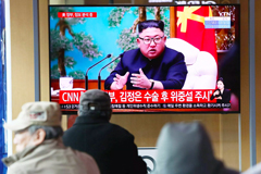 People watch archival footage of North Korean leader Kim Jong Un at the Seoul Railway Station on April 21. 