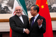 China's Foreign Minister Wang Yi (r) shakes hands with Iran's Foreign Minister Javad Zarif during a meeting in Beijing on Dec. 31, 2019. (NOEL CELIS/POOL/AFP VIA GETTY IMAGES)