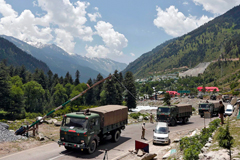 Indian army trucks move along a highway leading to Ladakh on Wednesday. (Danish Ismail/Reuters)