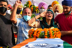  Sandeep Kaur and her brother Prabhjot Singh lay flowers on the coffin of their father, Satnam Singh, who was killed in the fight in the Galwan Valley. Photograph: Narinder Nanu/AFP/Getty Images