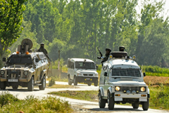 Military vehicles with armed solders inside