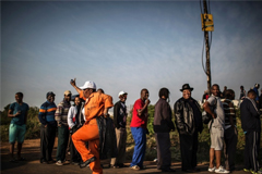 A municipal worker dances as voters line up in a township near Durban to cast their votes in South Africa’s Aug. 3 elections. 