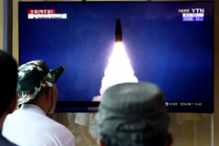  People watch a TV showing a file image of a North Korean missile launch at the Seoul Railway Station on August 6, 2019, in Seoul. Chung Sung-Jun/Getty Images 