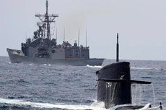 The 'Zwaardvis'-class submarine ROCS 'Hai Lung' surfaces near a Republic of China Navy frigate. REPUBLIC OF CHINA NAVY