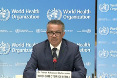 The head of the World Health Organization, Dr Tedros Adhanom Ghebreyesus speaking at a podium with the World Health Organization backdrop behind him