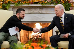 President Joe Biden shakes hands with Ukrainian President Volodymyr Zelenskyy as they meet in the Oval Office of the White House, Tuesday, Dec. 12, 2023